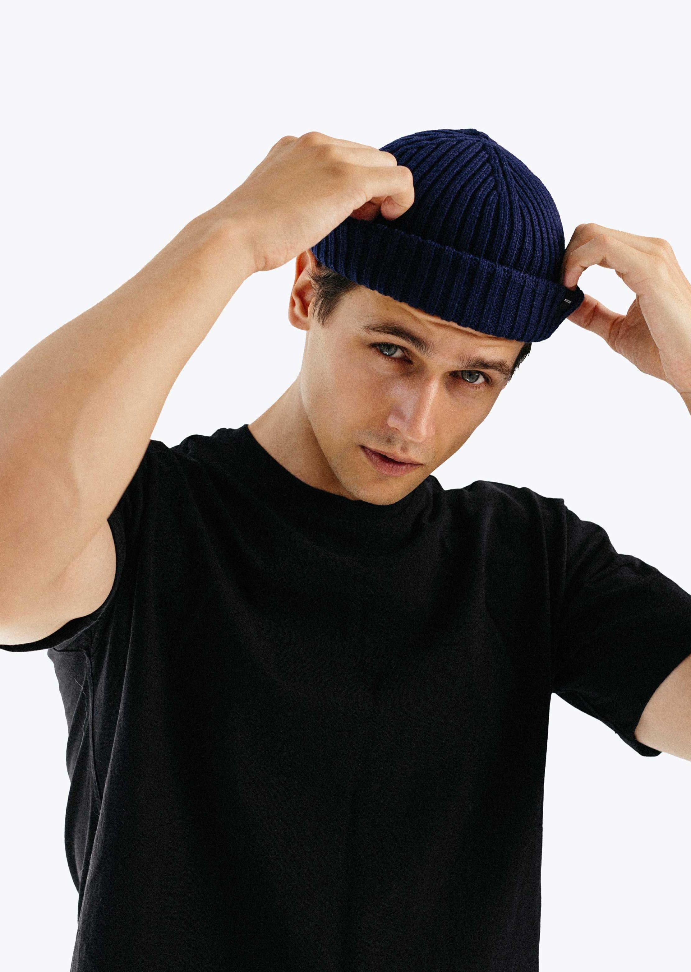 Model male wearing navy blue fisherman beanie